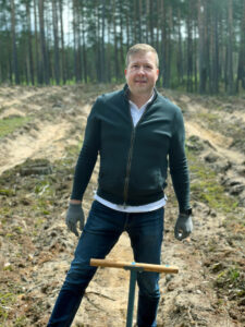 Justas Kaveckas Posing While Planting Tree